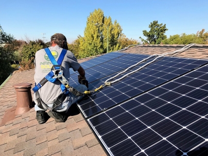 Infinium Solar technician installing solar panels